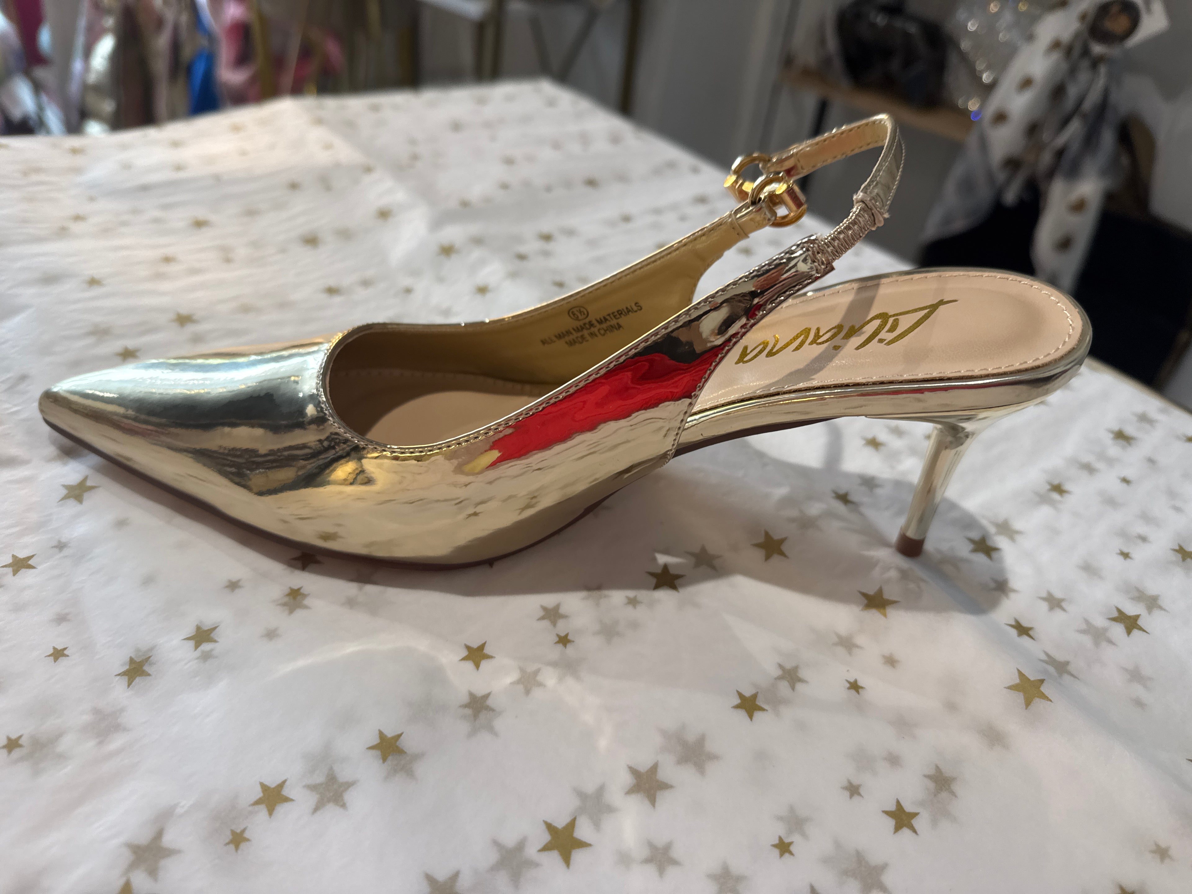 Gold slingback kitten heel.